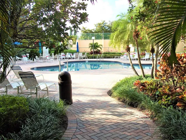 a view of a lake with a bench and trees around