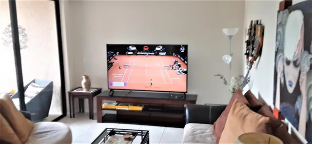 a room with furniture and a flat screen tv