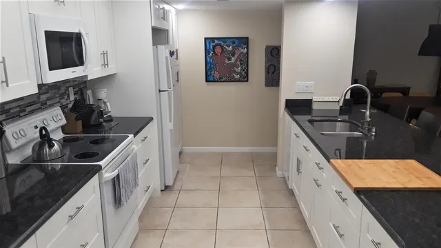 a kitchen with stainless steel appliances a sink stove and cabinets