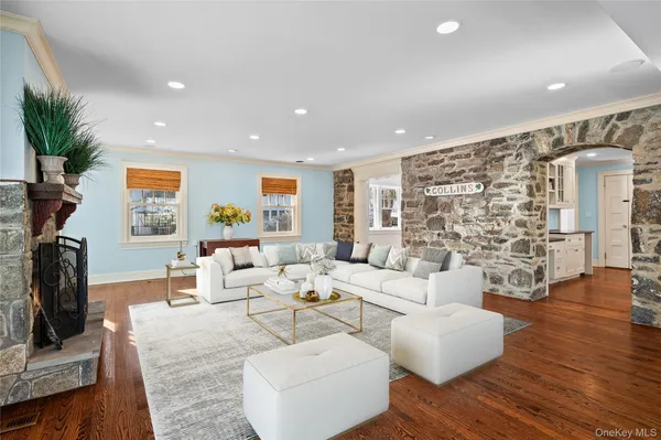a living room with fireplace furniture and a wooden floor