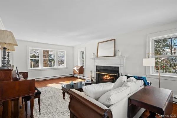 a living room with furniture fireplace and window