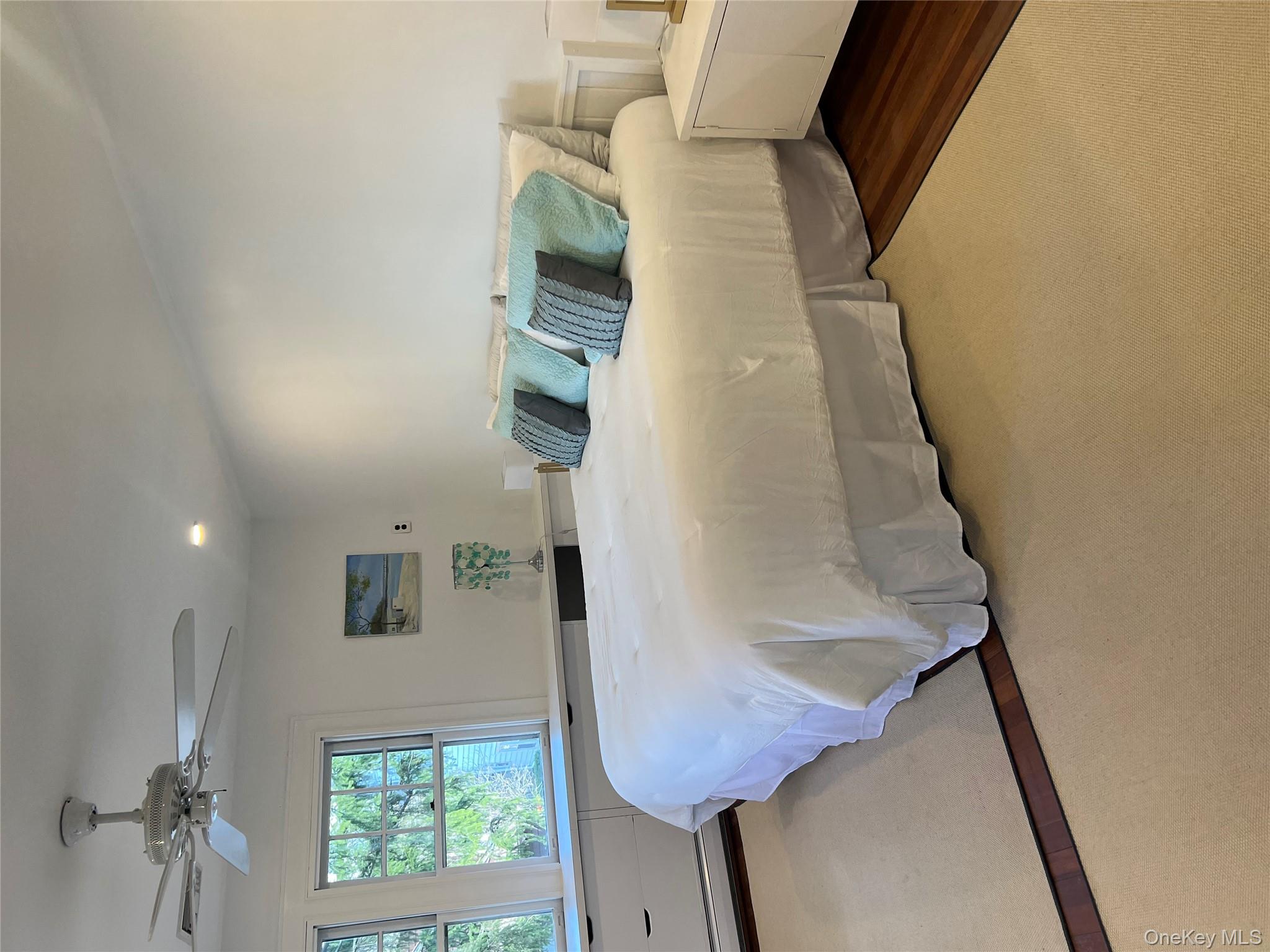 525 Milton Road Rye, NY 10580 - Photo 22 of 42 a bedroom with a bed and window