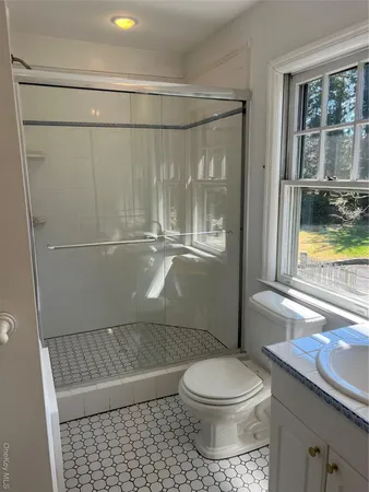 a bathroom with a toilet and a shower