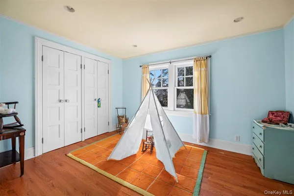 a view of a room with wooden floor and windows