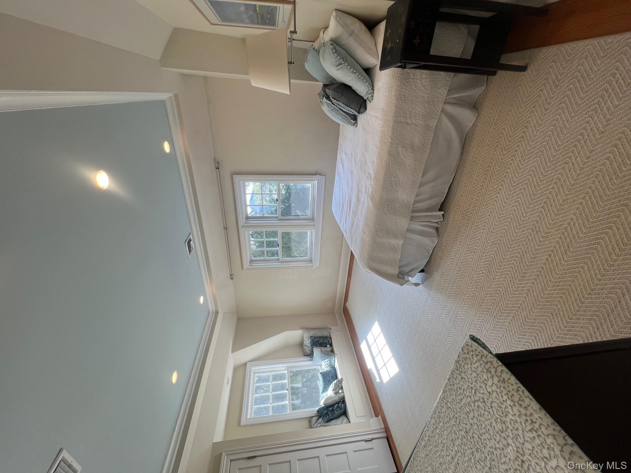 525 Milton Road Rye, NY 10580 - Photo 30 of 42 a bedroom with a bed and window