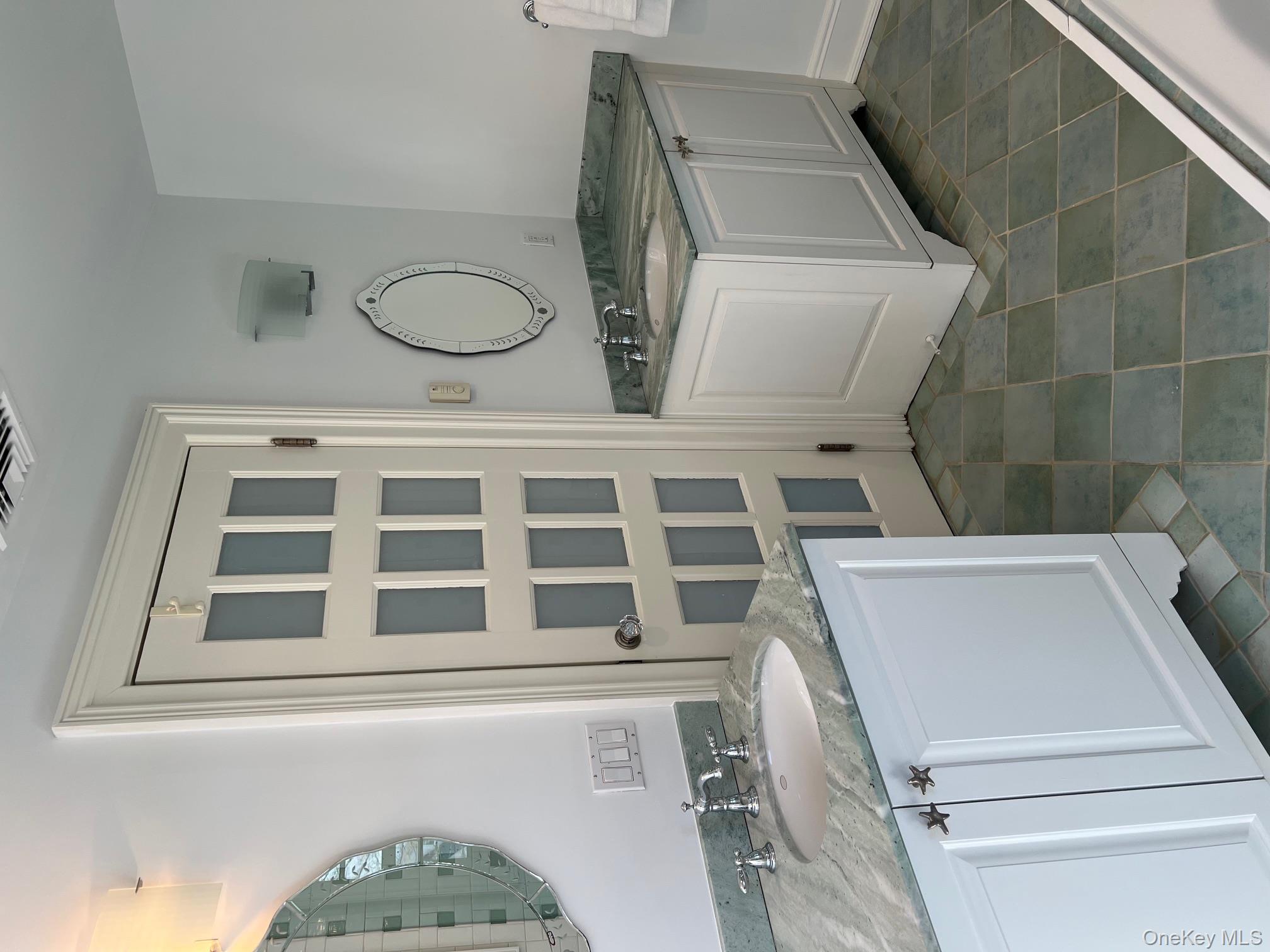 525 Milton Road Rye, NY 10580 - Photo 32 of 42 a bathroom with a granite countertop double vanity sink and a mirror