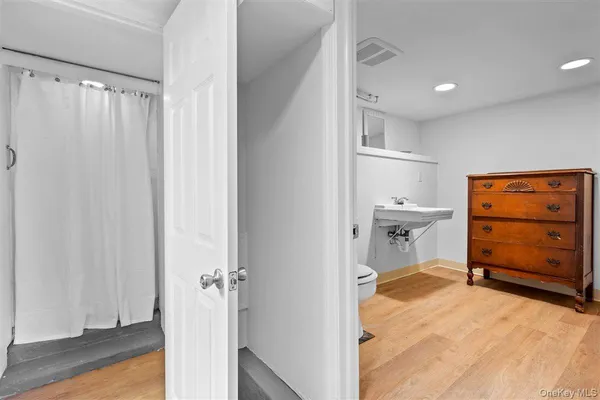 a view of a bedroom with a furniture and wooden floor