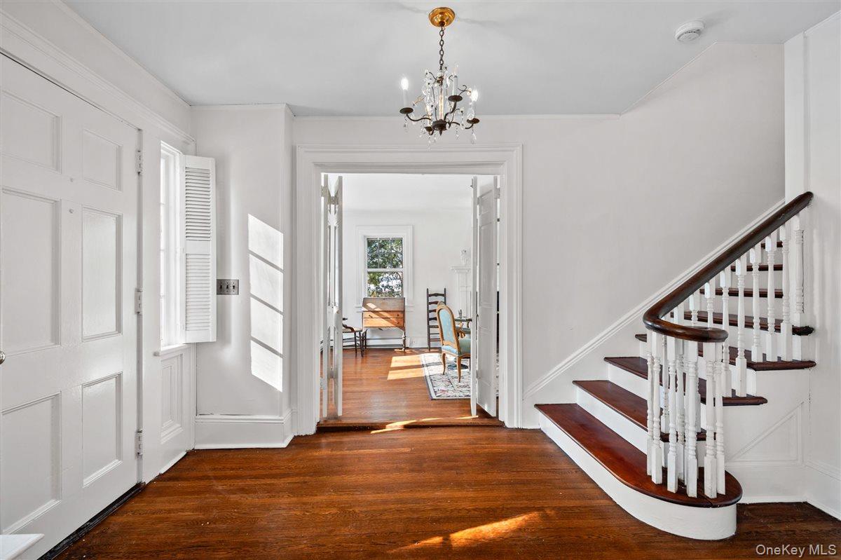 525 Milton Road Rye, NY 10580 - Photo 7 of 42 a view of a hallway with wooden floor and staircase