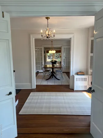 a living room with furniture and a chandelier