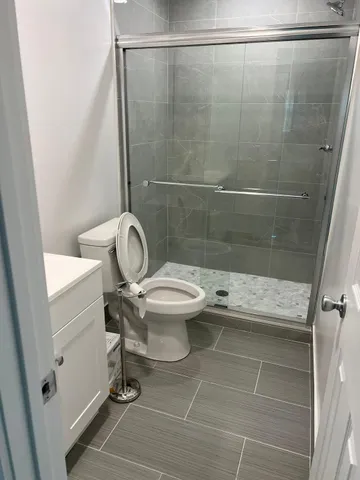 a bathroom with a toilet and a shower