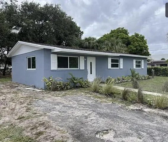 a view of a house with a yard and plants