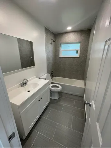 a bathroom with a sink a toilet and mirror