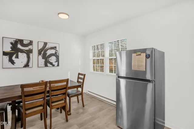 a kitchen with a refrigerator and a table