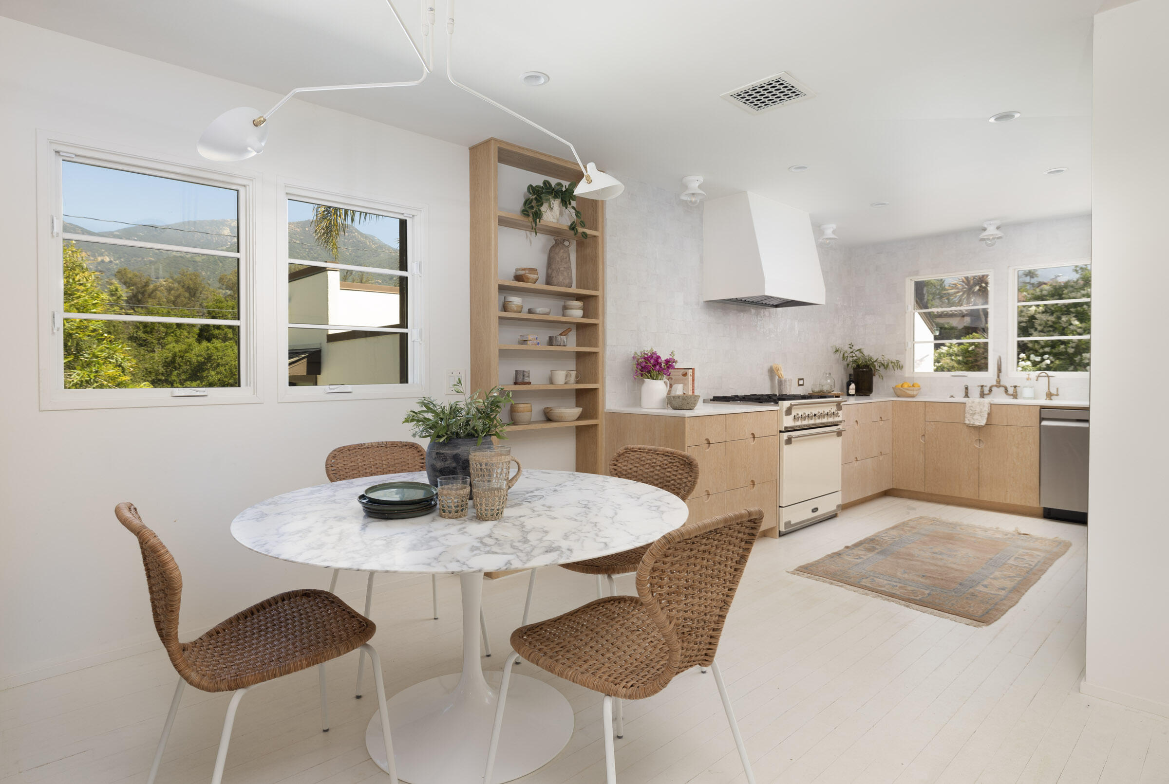 925 Chelham Way Montecito, CA 93108 - Photo 5 of 16 a kitchen with a dining table and chairs