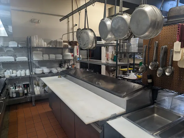 a kitchen with lots of counter space and stainless steel appliances