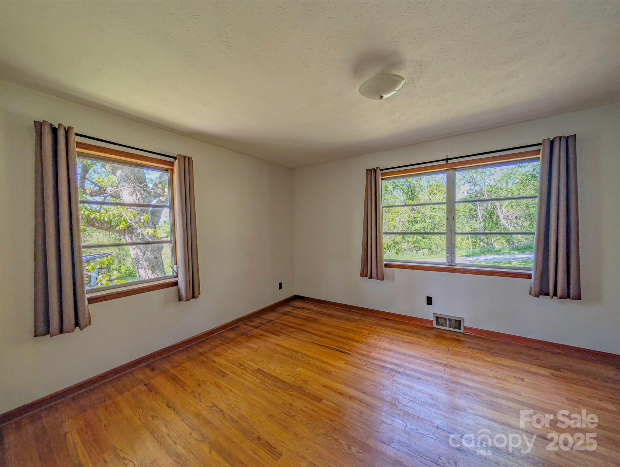 56 Gill Branch Road Weaverville, NC 28787 - Photo 13 of 47 a view of an empty room with wooden floor and a window