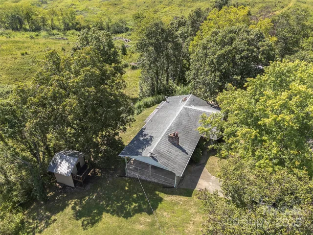 a view of a field with an trees around