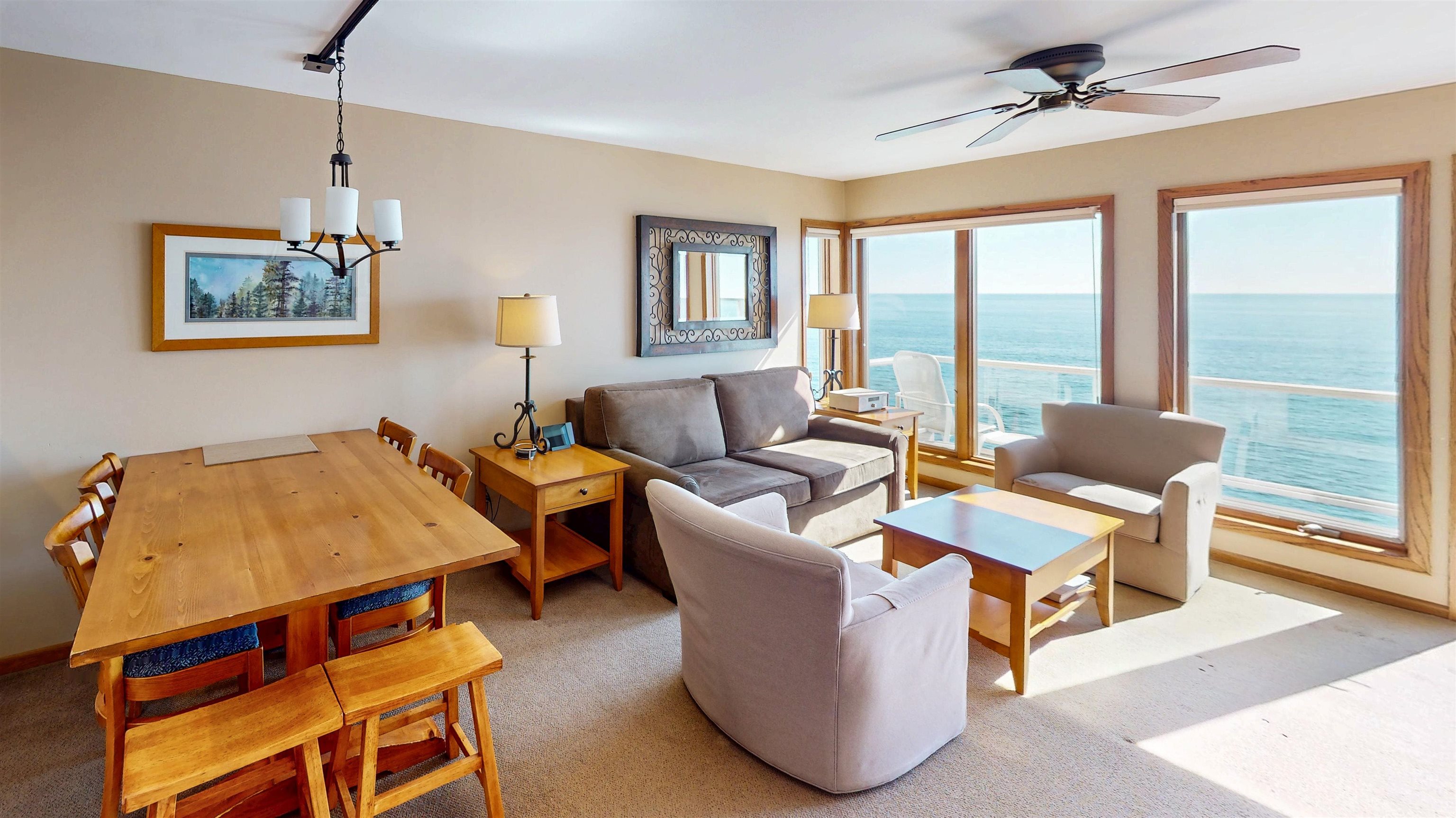 7192 Highway 61, Unit 37 Tofte, MN 55615 - Photo 7 of 15 Living area with a water view, a chandelier, carpet flooring, and ceiling fan