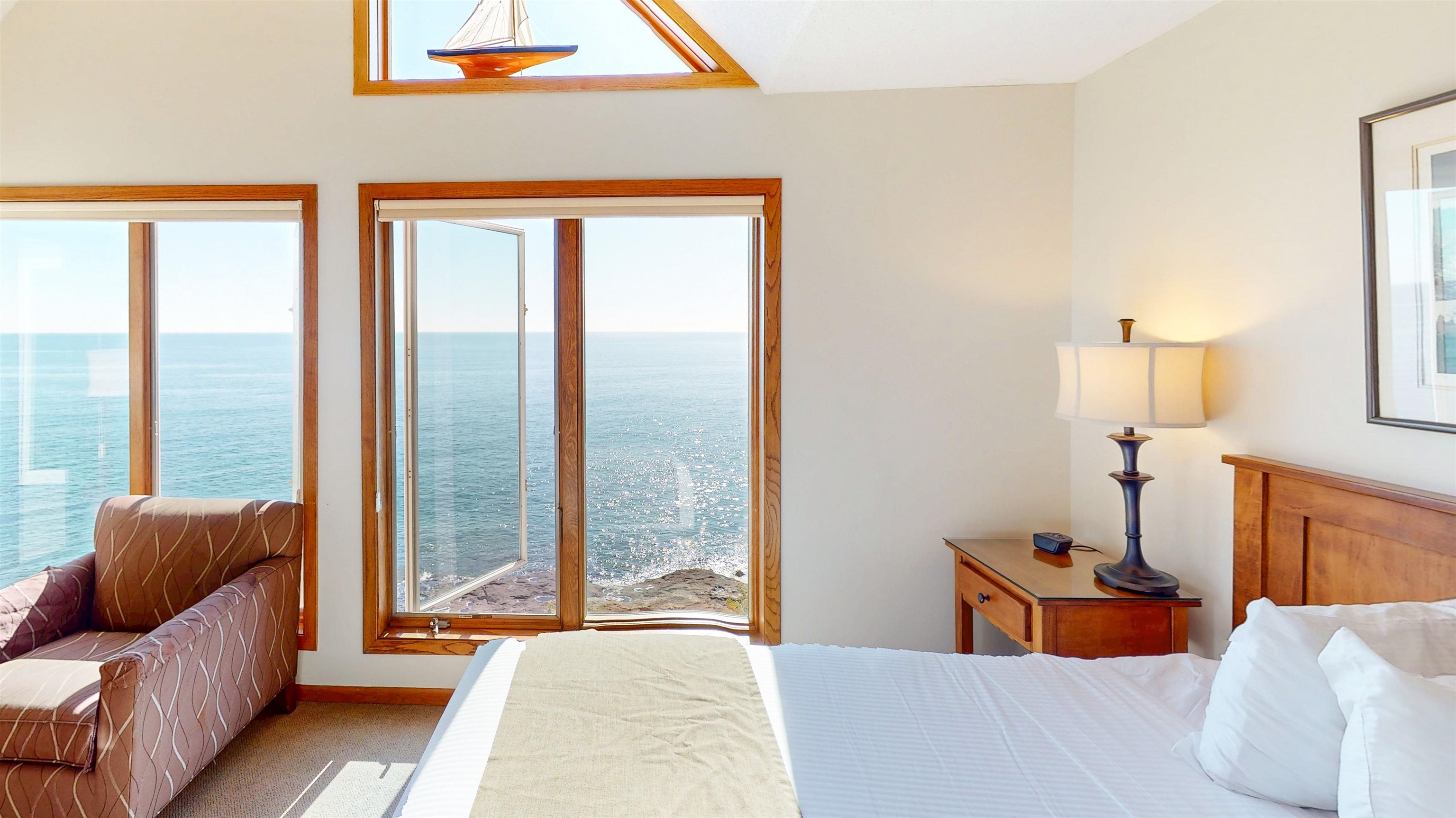 7192 Highway 61, Unit 37 Tofte, MN 55615 - Photo 8 of 15 Bedroom with a water view, multiple windows, and carpet