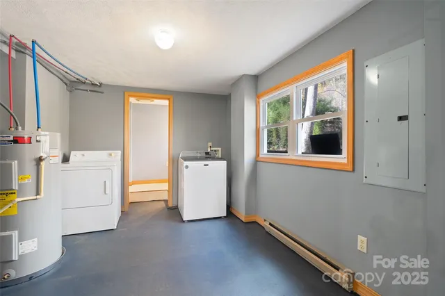 a bathroom with a granite countertop sink toilet and a window