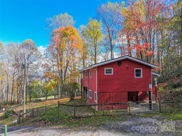 a view of a small house with a yard