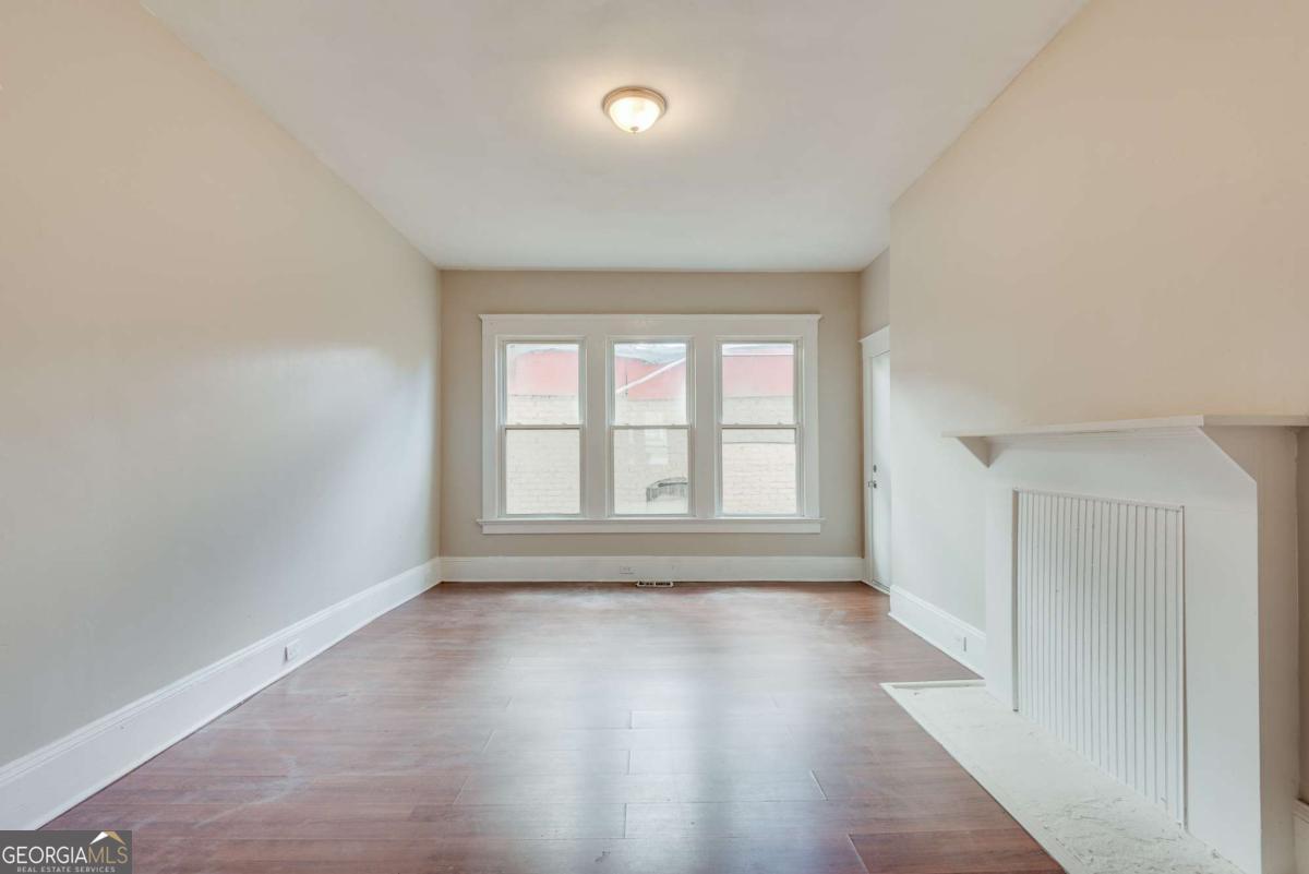 1330 Allene Avenue Southwest Atlanta, GA 30310 - Photo 12 of 24 an empty room with wooden floor and windows
