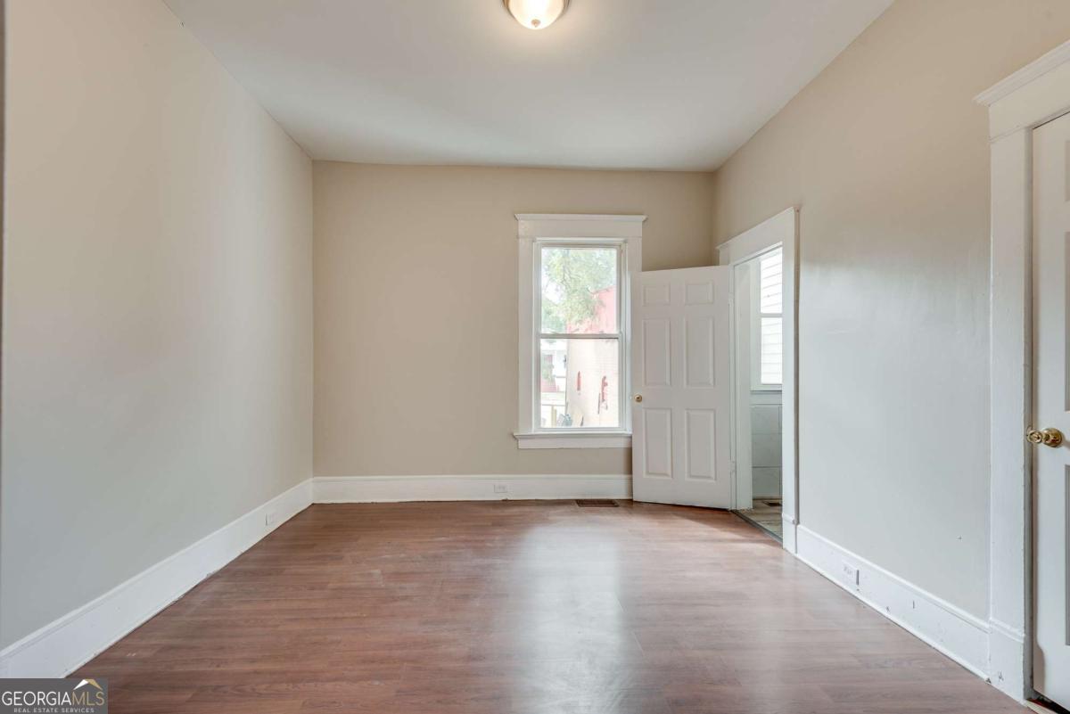 1330 Allene Avenue Southwest Atlanta, GA 30310 - Photo 16 of 24 an empty room with wooden floor and windows