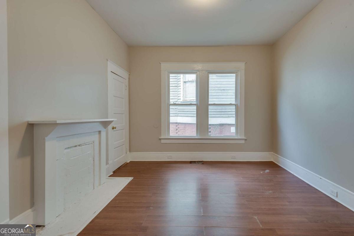 1330 Allene Avenue Southwest Atlanta, GA 30310 - Photo 20 of 24 an empty room with wooden floor and windows