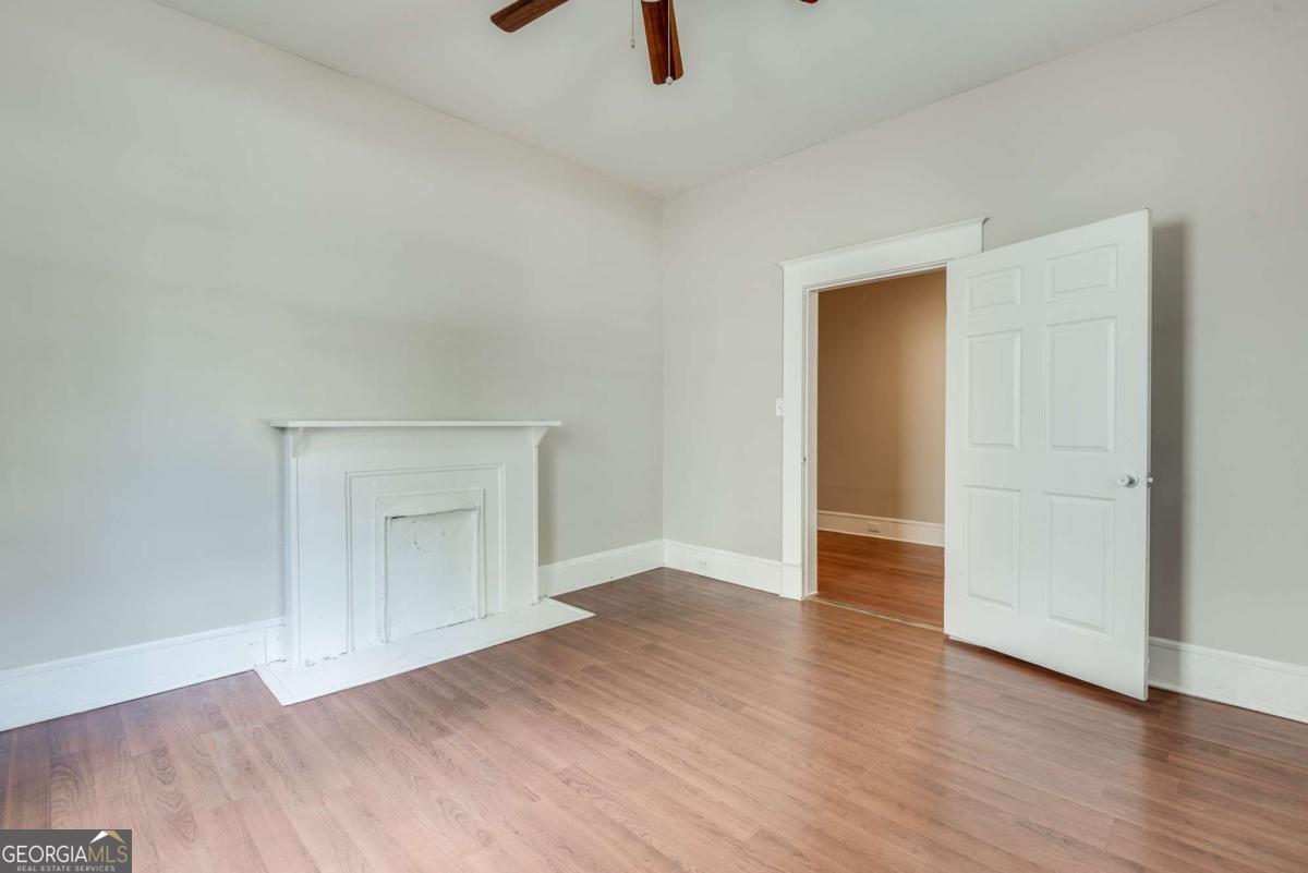 1330 Allene Avenue Southwest Atlanta, GA 30310 - Photo 2 of 24 an empty room with wooden floor and windows