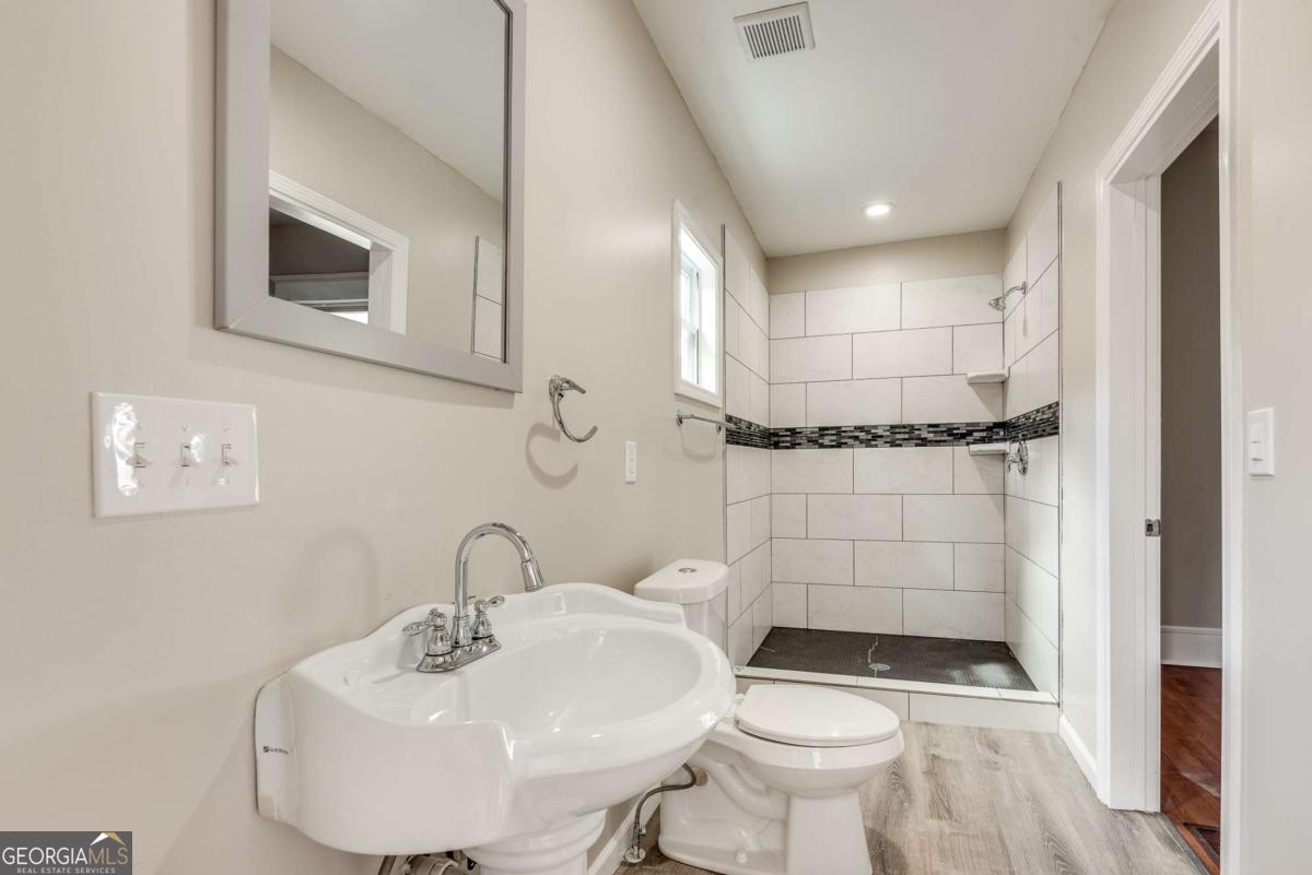 1330 Allene Avenue Southwest Atlanta, GA 30310 - Photo 23 of 24 a bathroom with a sink toilet and shower