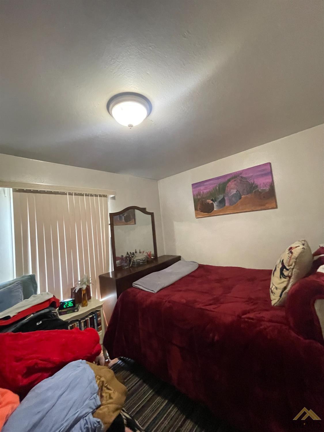 Undisclosed Address Bakersfield, CA 93304 - Photo 11 of 14 a bedroom with a bed and a couch
