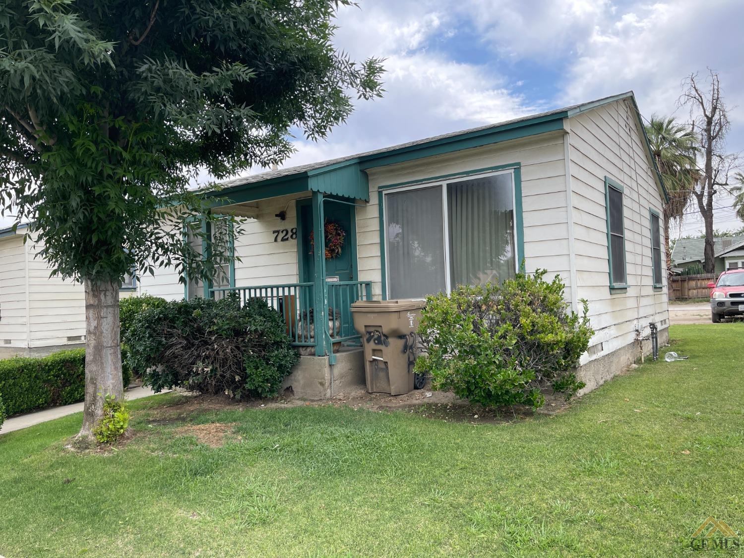 Undisclosed Address Bakersfield, CA 93304 - Photo 2 of 14 front view of a house with a yard
