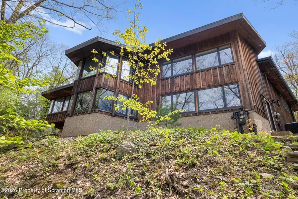 a house view with a sitting space and garden