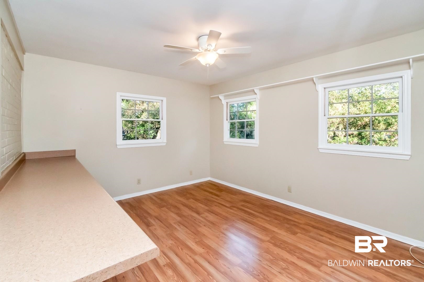 308 Brawood Drive Mobile, AL 36608 - Photo 10 of 33 Unfurnished room with ceiling fan, light hardwood / wood-style flooring, and a healthy amount of sunlight