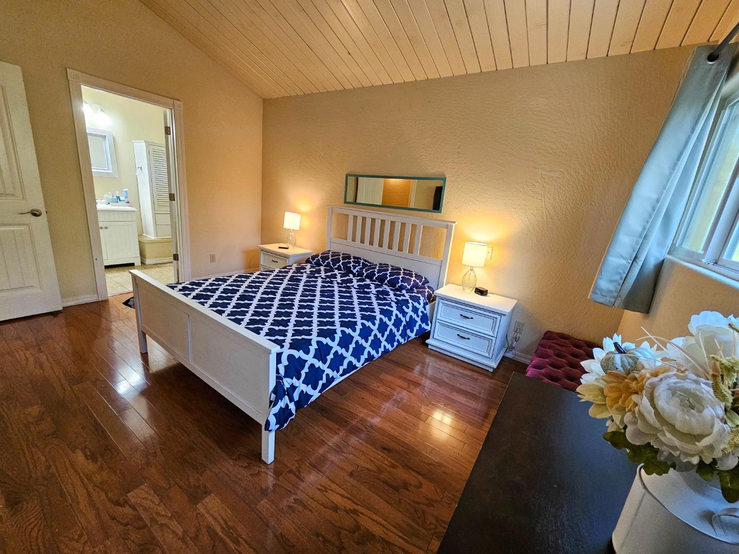 19418 Ferretti Road Groveland, CA 95321 - Photo 19 of 35 a bed sitting in a bedroom next to a window and flowerpot