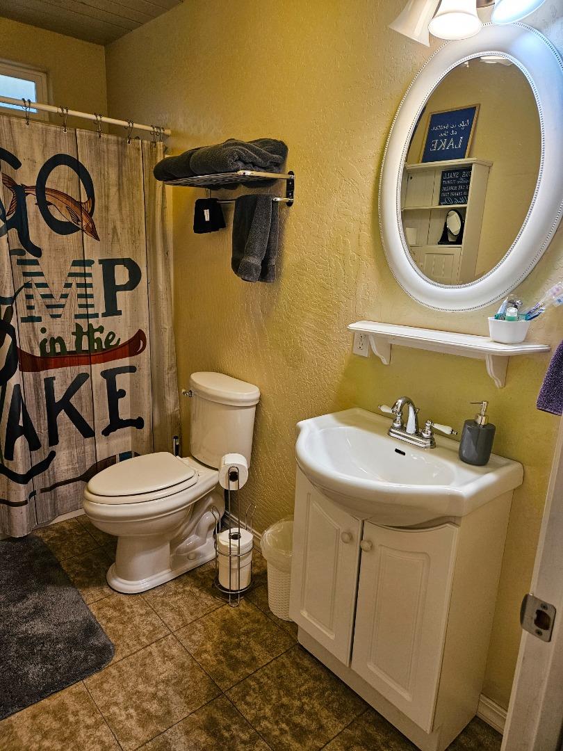 19418 Ferretti Road Groveland, CA 95321 - Photo 20 of 35 a bathroom with a sink and mirror with toilet
