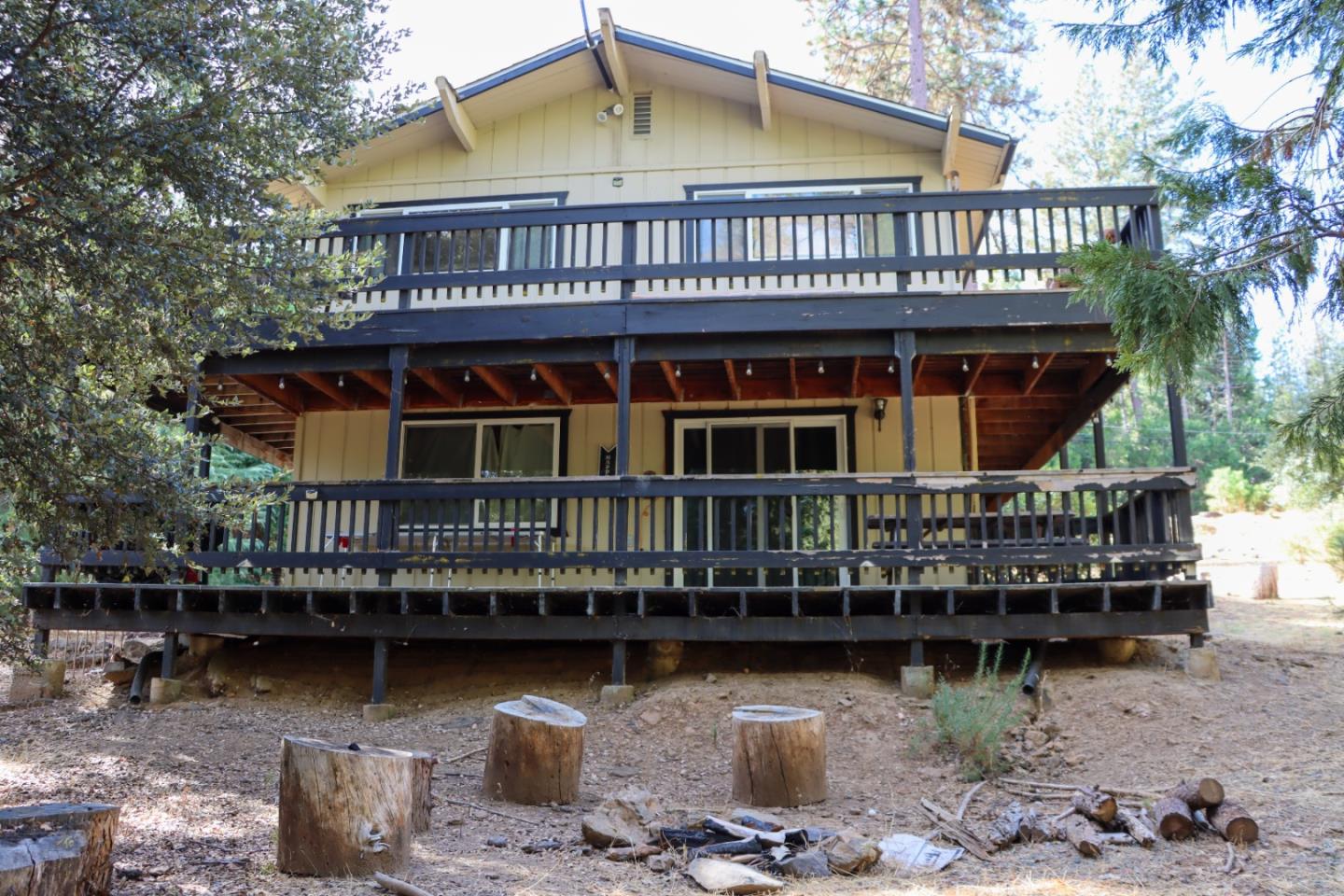 19418 Ferretti Road Groveland, CA 95321 - Photo 2 of 35 a roof deck with table and chairs under an umbrella