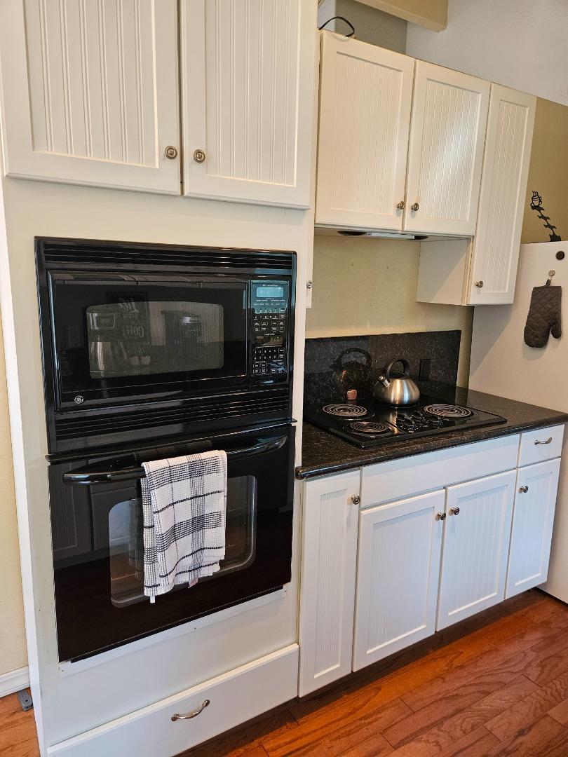19418 Ferretti Road Groveland, CA 95321 - Photo 5 of 35 a kitchen with white cabinets stainless steel appliances and sink