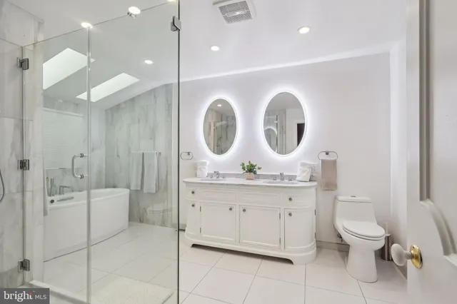 a spacious bathroom with a double vanity sink and a mirror