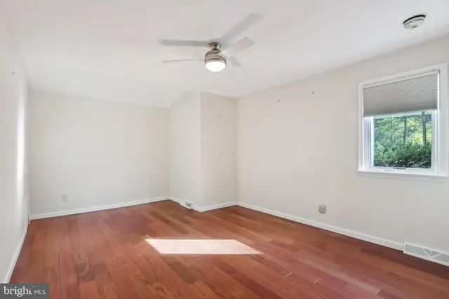 a view of a room with wooden floor and window