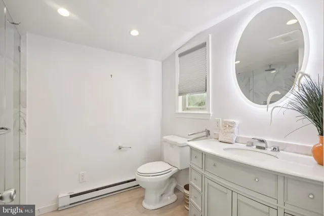 a view of a livingroom with wooden floor and flat screen tv