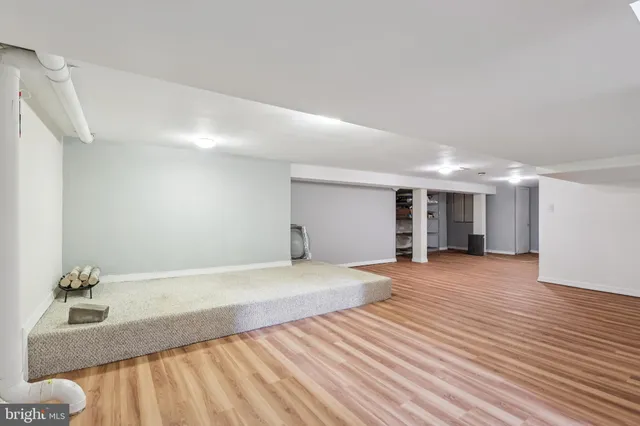a view of a patio with chairs and potted plants