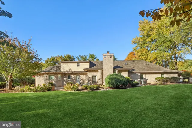 an aerial view of a house with a garden and trees