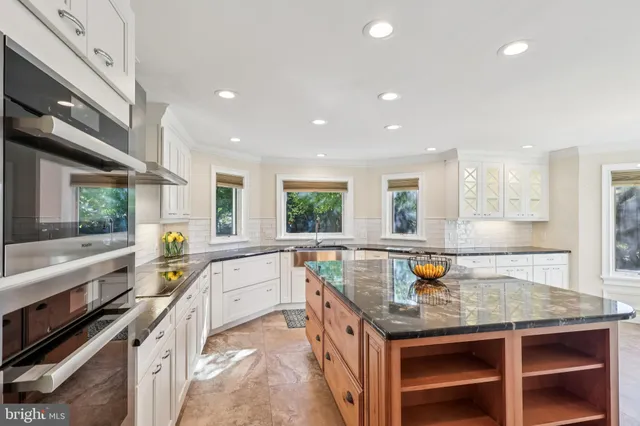 a kitchen with a sink stove and table