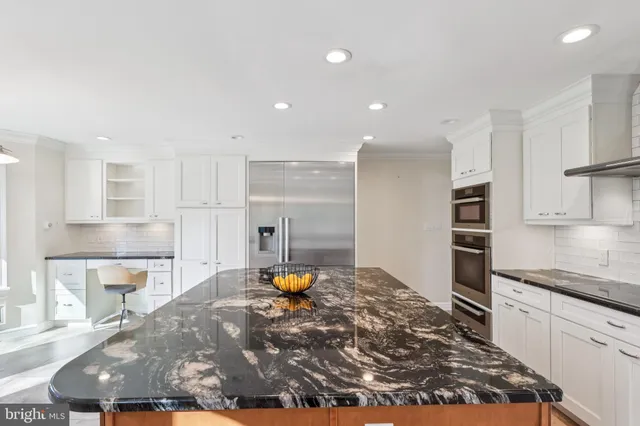 a kitchen with stainless steel appliances a refrigerator and a stove top oven