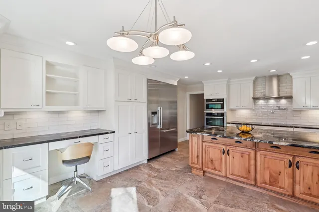 a kitchen with stainless steel appliances granite countertop a sink and cabinets