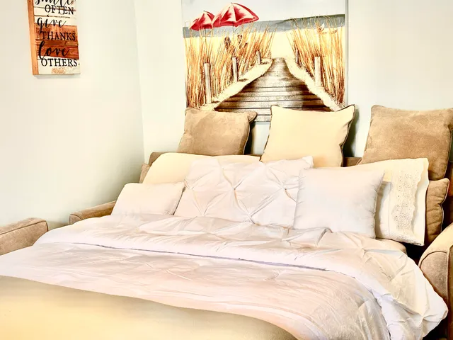 a bedroom with a bed and a night stand