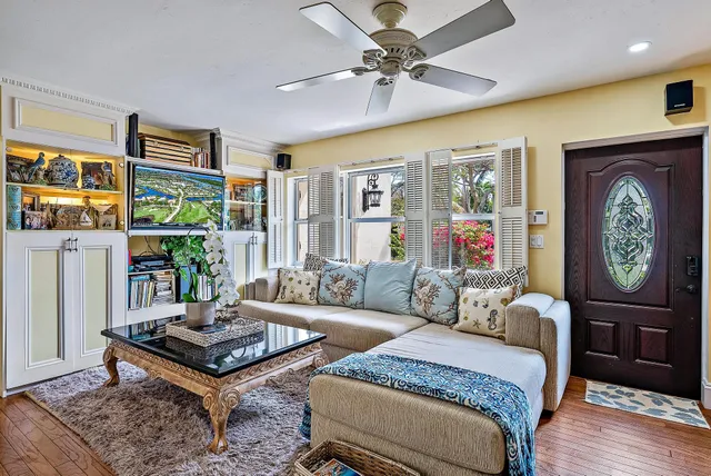 a living room with furniture a rug and a window