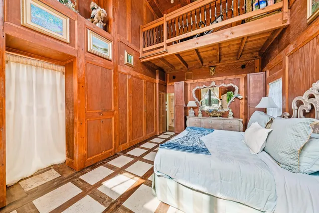 a bedroom with a bed window and a desk