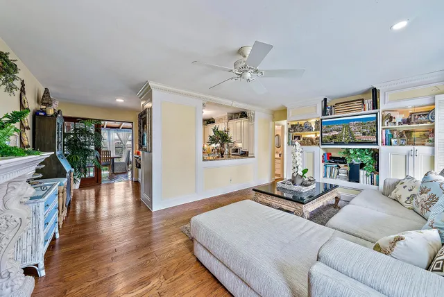 a living room with furniture and a wooden floor
